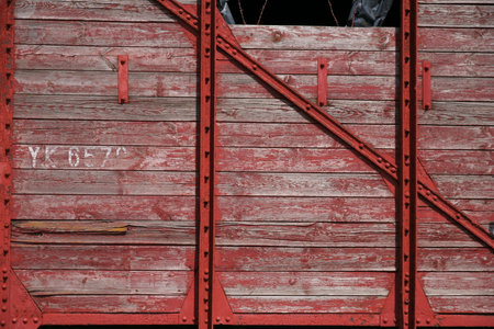 Wooden gate with red paint, close-up, background, textureの写真素材