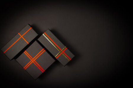 Black gift boxes on black background. Top view with copy space.の写真素材