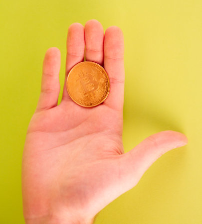 Bitcoin in the hand on a green background. Cryptocurrency.の写真素材