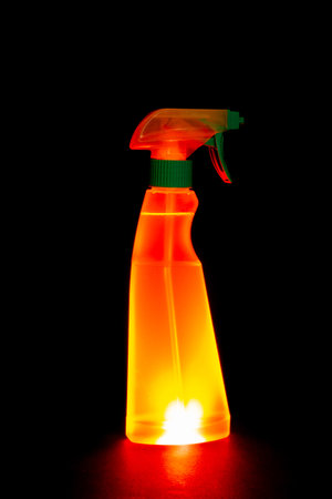 Spray bottle isolated on black background. Close-up view.の写真素材