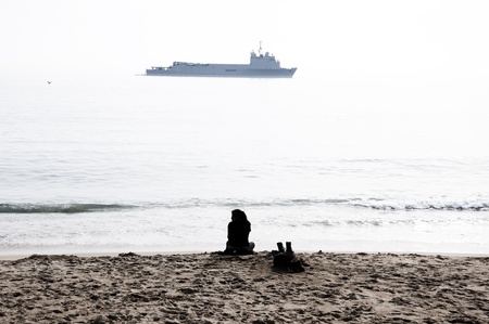 Woman and boat in the distanceの写真素材