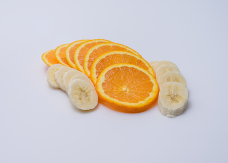 Banana slices around orange slicesの写真素材