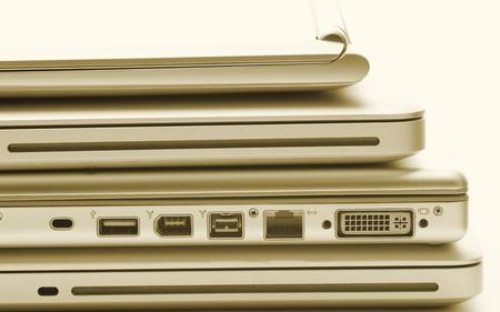 Laptops stack with gold filterの写真素材