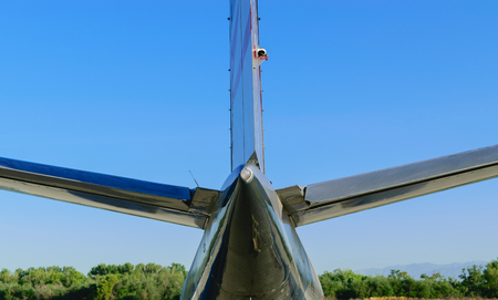 Tail section of airplane with blue sky backgroundの写真素材