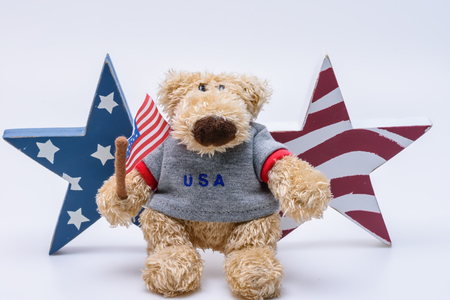USA patriotic bear in front of stars flagの写真素材
