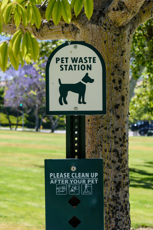 Pet waste station with supplies at trail entranceの写真素材