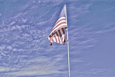 Torn USA flag with HDR filter appliedの写真素材