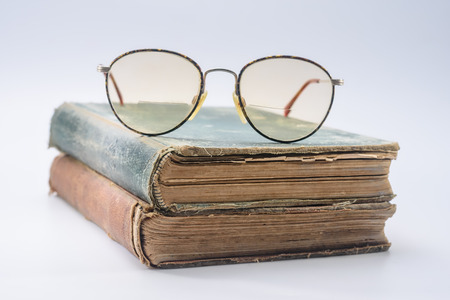 Large round reading glasses on two vintage booksの写真素材