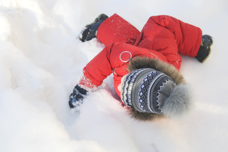 Portrait of a child in winter clothes, a walk through a winter park,の写真素材