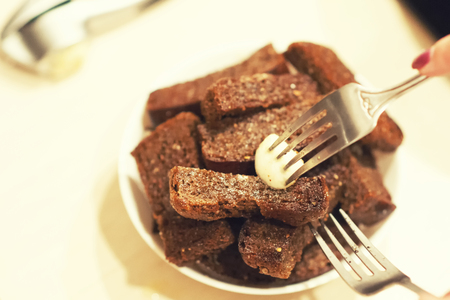 Fried garlic croutons, black bread on a white plateの写真素材