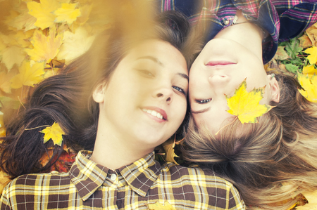 Two young girls on a walk in the autumn parkの写真素材
