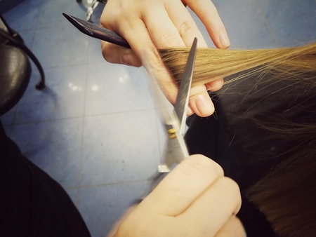 Haircut in the beauty salon, polishing hair with a special typewriter with a nozzle, healthy hair, close-up,の写真素材