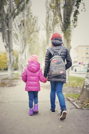 Children go holding hands, child and teenager,の写真素材