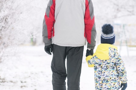 Father holds the boys hand in winter clothes, winter, family, hand in hand, lifestyleの写真素材