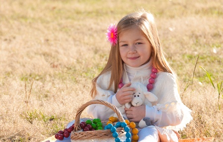 Beautiful little girl with a basket in anticipation.