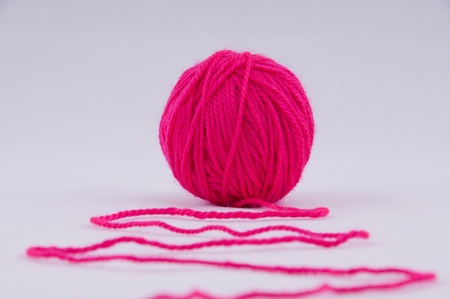 A ball of yarn for knitting on a grey backgroundの写真素材
