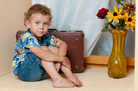Cute little boy with the flower. He is wearing a hat.の写真素材