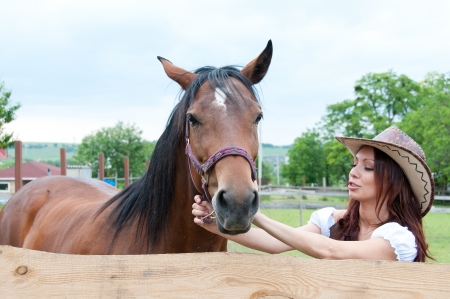 Beautiful brunette girl with horseの写真素材