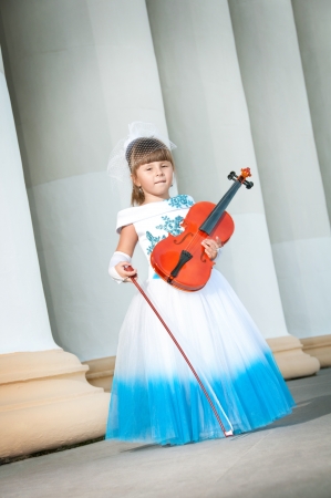 Violinist. Pretty girl in a smart dress with a violin.の写真素材