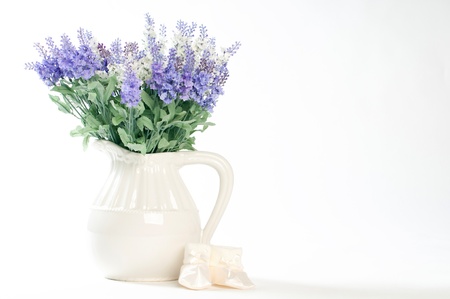 wild flowers in a white vase on a white background.の写真素材
