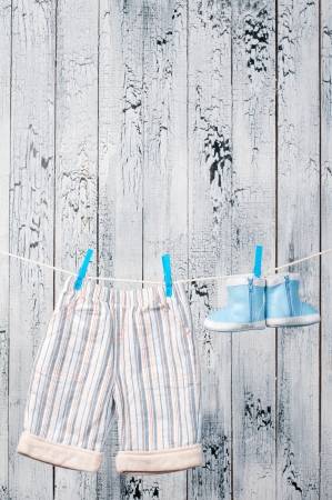 Baby clothes hanging on the clothesline の写真素材