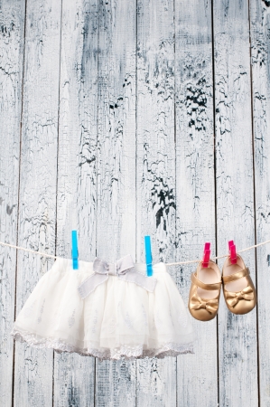 Baby clothes hanging on the clothesline の写真素材
