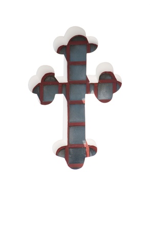 The window in the shape of a cross in a white wall.