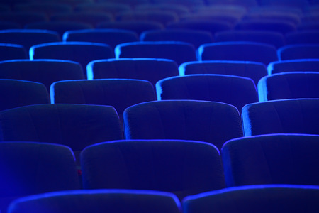 Empty comfortable green seats in theater, cinemaの写真素材