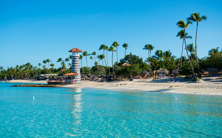 Paradise tropical island in Dominican Republic. White sand, blue sea, clear sky and  lighthouse on shoreの写真素材