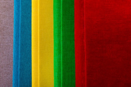 Multicolored book textile cover. Photobooks on a white background