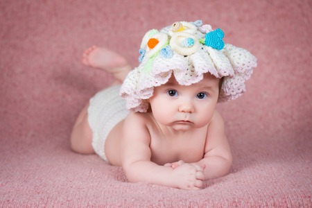 Newborn baby in a warm knitted hatの写真素材