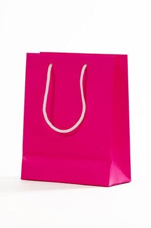Pink paper bag isolated on white background.の写真素材