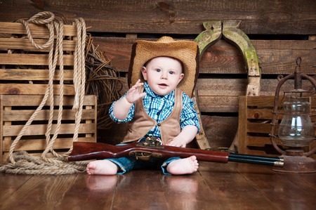 Portrait of a small boy in cowboy decorの写真素材