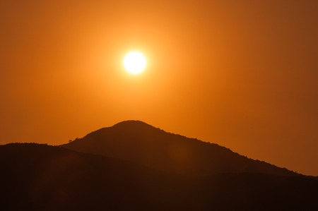 Orange sunset in the mountains. View from a heightの写真素材