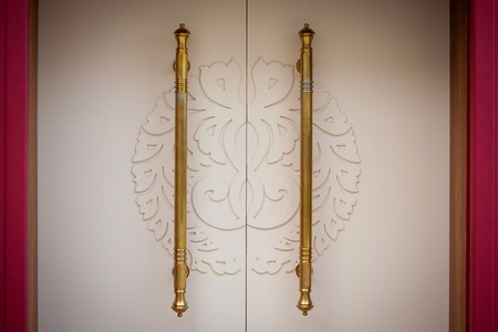 Beautiful white doors with golden handles. backgroundの写真素材