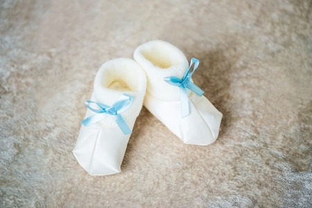 Baby booties with blue ribbons. Waiting for the boyの写真素材