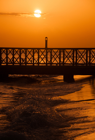 Sunset over the sea. Pier on the foreground. Panoramaの写真素材