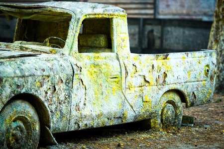 An old rusty car in paint from paintballの写真素材