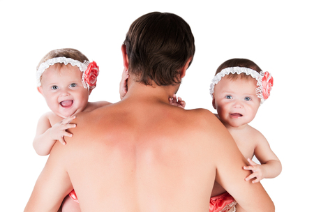 Dad with two daughters in arms, twins.の写真素材