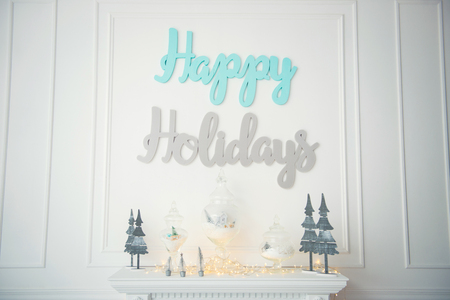 Decorative Inscription on the white wall Happy Holidays. New Years Eve 2018の写真素材