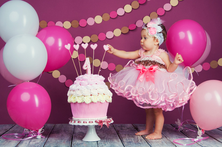 The little girls birthday girl was smeared into a cake. The first cake. The use of the first cake. Smash cake.の写真素材