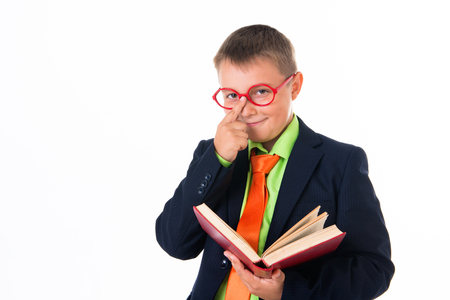 Boy reading a book thirsty for knowledge - isolated over a white background.の写真素材