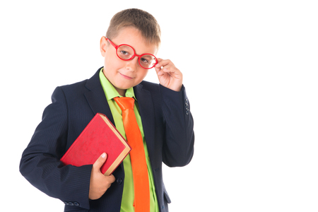 Boy reading a book thirsty for knowledge - isolated over a white background.の写真素材
