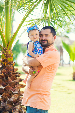 Happy father and his sweet little daughter at beach.の写真素材