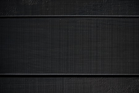 Wood texture. black timber board with weathered crack lines. Natural background for shabby chic design. Black wooden floor image. Aged tree surface close-up backdrop templateの写真素材