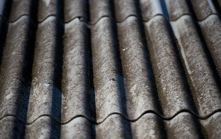 old gray slate roof as background. Texture construction.