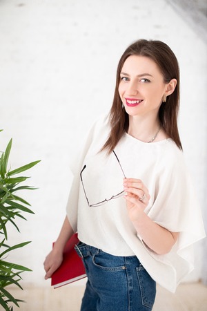 young bussiness girl is standing with notebook.の写真素材