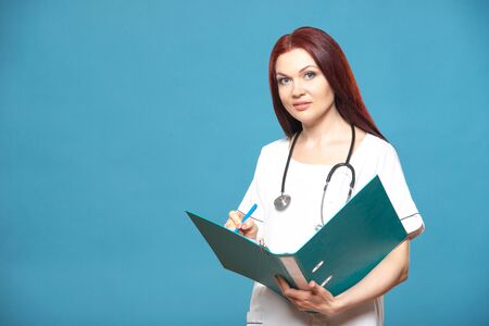 Family female woman doctor with a stethoscope holds folder with documents, has friendly expression,...