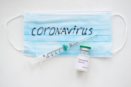 Medical mask and syringe and needles a Coronavirus infection and protection concept.の写真素材