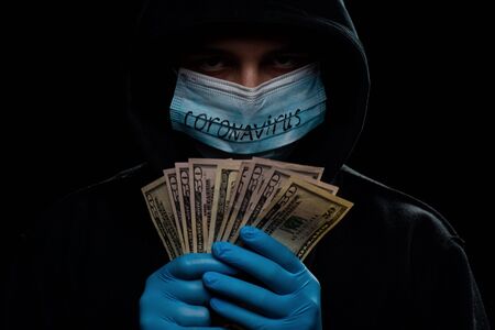 Concept of the global financial crisis. World pandemic virus COVID-19 coronavirus. Panic, black and shadow business and speculation.の写真素材
